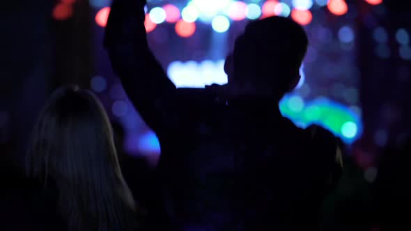 Happy Male Dancing, Waving Hands and Shooting Concert on Smartphone at Nightclub