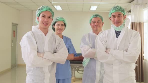 Portrait of Asian group of doctor put protective surgical mask on to prevent covid virus pandemic.