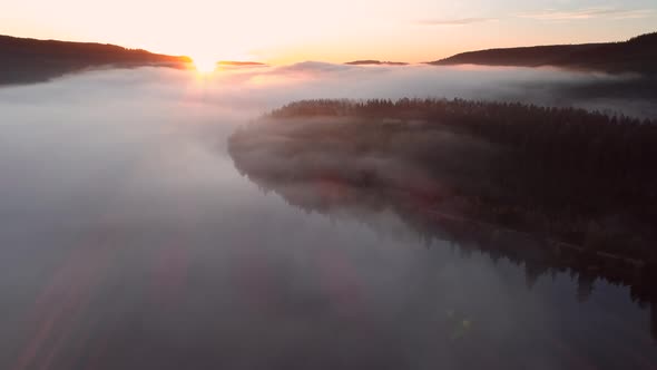 Aerial view of sunrise with fog above lake Schluchsee, Germany