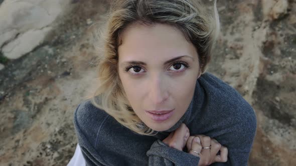 be cold: young woman on the beach during cold and windy day