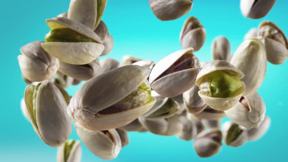 Flying of Pistachios in Ice Blue Background
