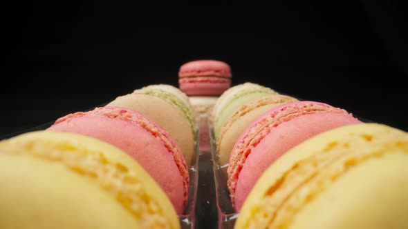 Colored Macaroons Confectionery Marshmallows on a Black Reflective Background in Perspective