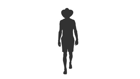 Silhouette of Walking Young Man in Shorts and Cowboy Hat