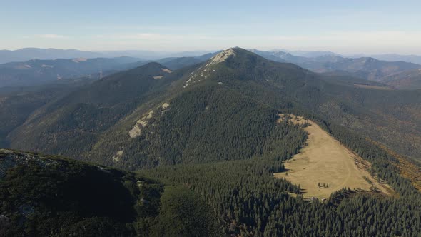 Aerial Landscape View of High Peaks with Dark Pine Forest Trees in Wild Mountains