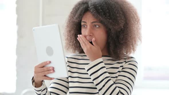 Surprised African Woman Having Success on Tablet