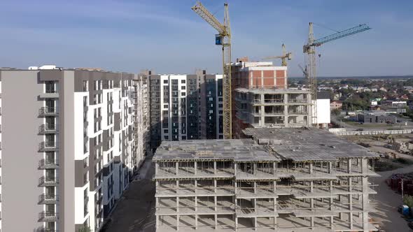 Building crane and monolituc building under construction. Construction site