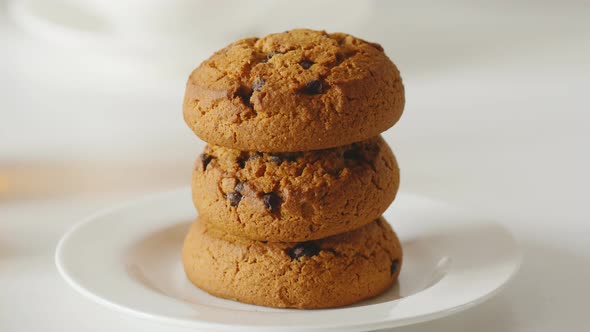 Closeup Oatmeal Cookies Poured with Liquid Chocolate on a White Table