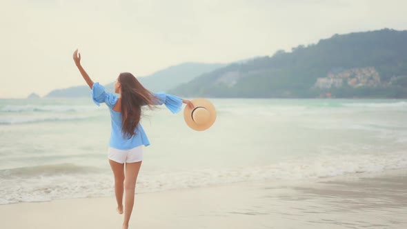 Asian woman enjoy around beautiful beach sea ocean