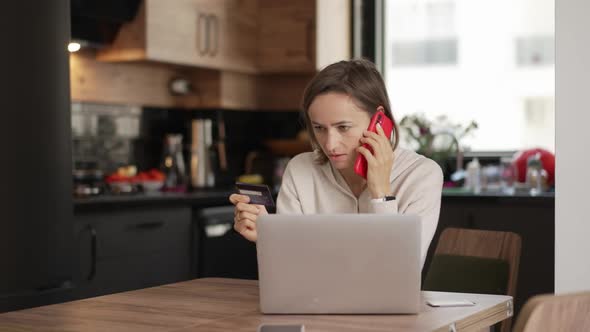 Upset Young Woman Using Online Banking Service Problem with Blocked Credit Card Using Laptop