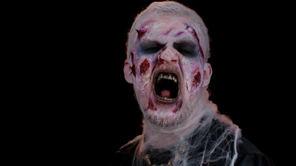 Creepy Man with Halloween Zombie Undead Bloody Wounded Makeup Trying to Scare Face Expressions