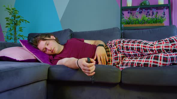 Guy Naps on Sofa with Remote Control Shudders