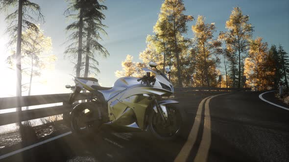 Sportbike on Tre Road in Forest with Sun Beams