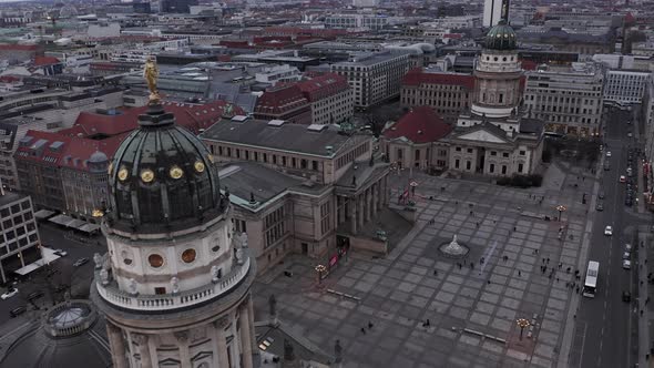 AERIAL: Slowly Passing Beautiful Old Church Over Plaza in the Center of Berlin Germany at Sunset 