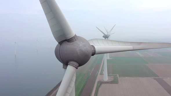 Aerial View of a Giant Wind Farm Used for Renewable Energy on a Foggy Day