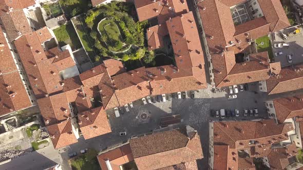 Top down aerial view of a small historic town Venzone in Northern Italy with red tiled roofs