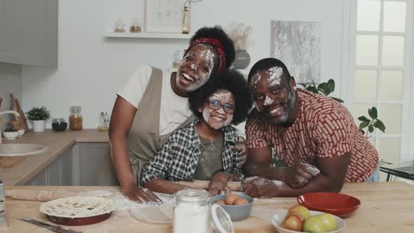 Portrait of Joyful African Family with Flour on Faces