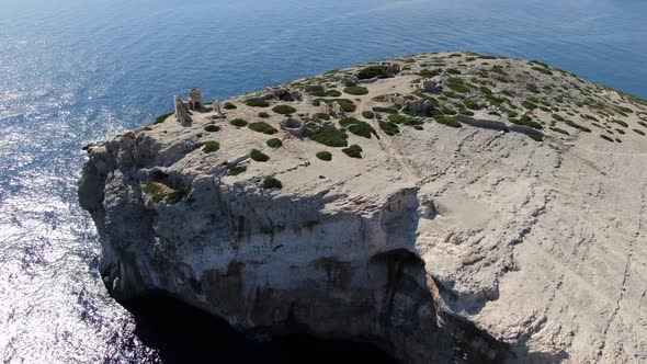 Flying over stone built ruins on Mana island in Kornati National Park, Croatia