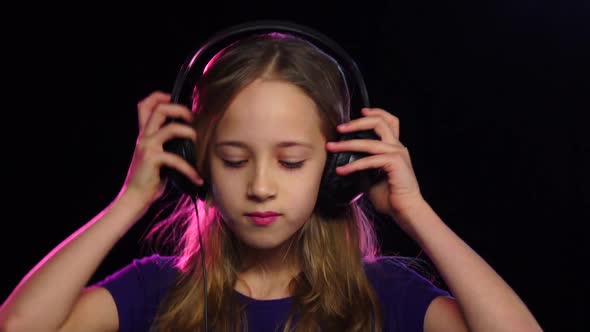 Cute Teenage Girl Wears Headphones and Starts Dance. Slow Motion