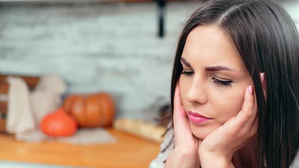 Closeup Face of Upset Girl with Natural Beauty Having Ache Pain Surrounded By Cuisine Interior