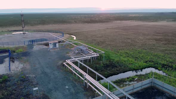 A Drone Flies Over a Gas Pipeline in an Oil and Gas Field in the Wild Far From Civilization