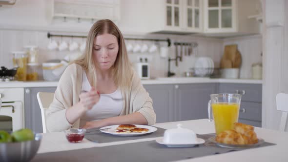 Woman Eating Pancakes in Morning