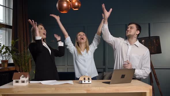 Team of Young Architect Throwing Paper in the Office