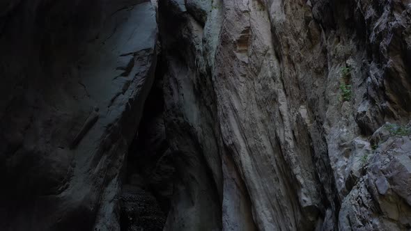 Camera move at the narrow canyon of a mountain gorge, illuminated by the sun