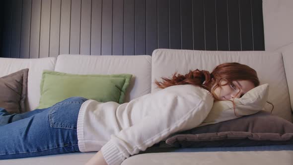 Exhausted Or Bored Young Sleepy Woman Falls Down On Sofa. Apathetic Tired Lazy Lady 