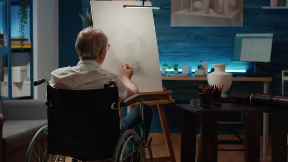 Senior Adult with Chronic Impairment Using Pencils to Draw Vase