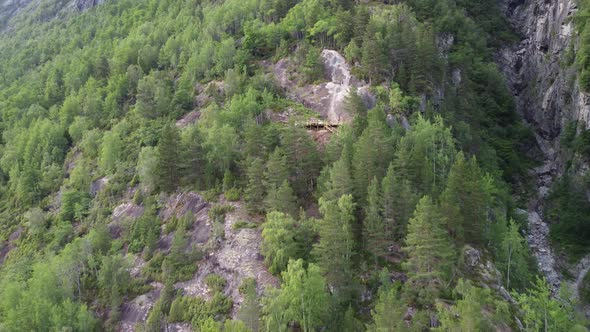 Upwarding aerial along Via Ferrata Loen mountain climbing trail - Risky path close to cliff at steep