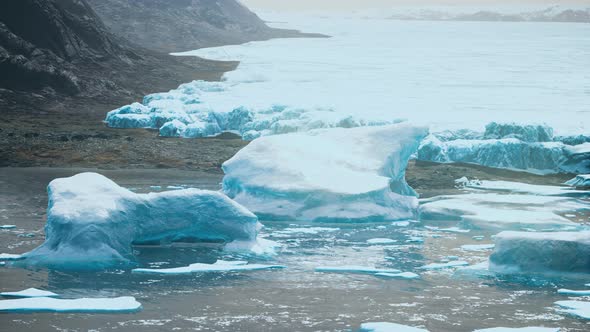 Antarctic Icebergs Near Rocky Beach