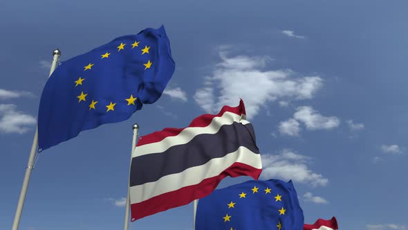 Flags of Thailand and the European Union Against Blue Sky