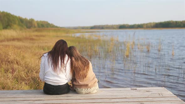 Beautiful Family at Autumn Warm Day Near Lake