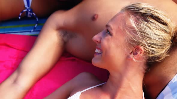 Group of friends lying on towels