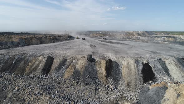 Truck Dumps Rocks into a Dump.