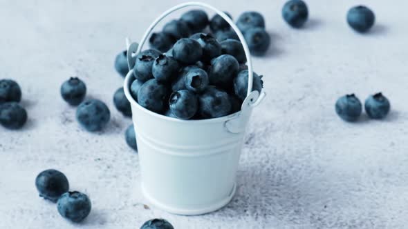 Blueberries in a Small Bucket on Concrete Background