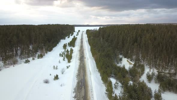 Car On The Winter Forest Road At Stormy Weather