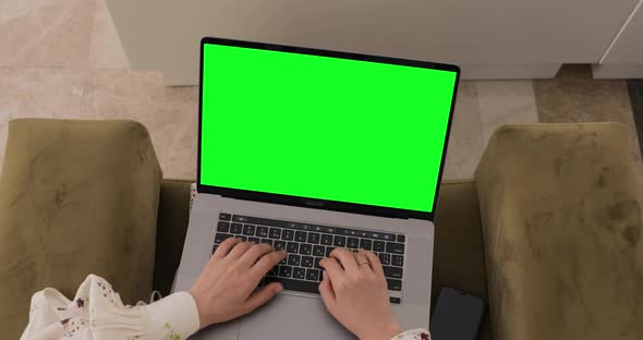 Laptop with green screen. Woman sitting in lobby, Texting email online. Business journey concept.