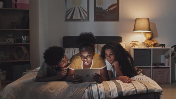 Young Aunt with Kids in Bed