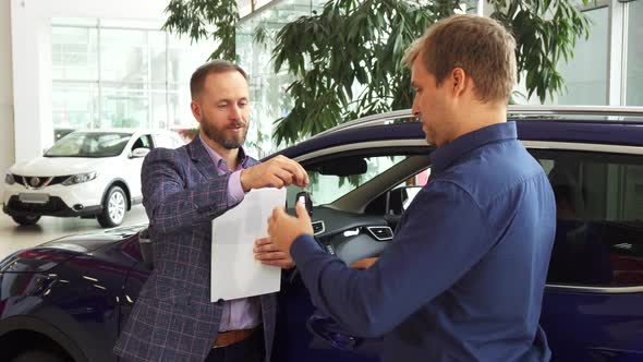 Car Dealer Hands Over the Keys To the New Owner