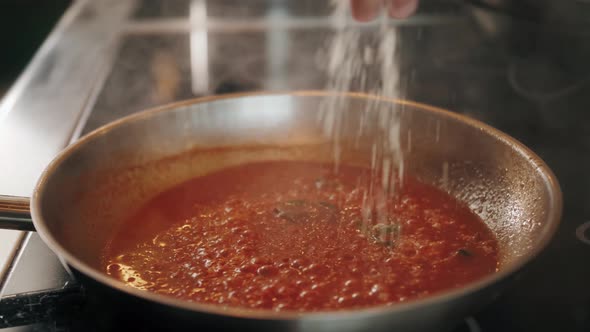 Chef Cooking Tasty Pasta Tomato Sause on Restaurant Kitchen Add Spices Traditional Italian Food High