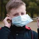 Child Boy Takes Off His Medical Mask Outdoors - VideoHive Item for Sale