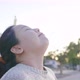 Close up of Asian woman standing and taking deep breath at park - VideoHive Item for Sale