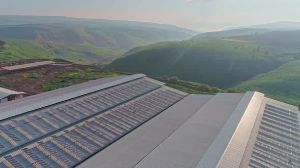 Aerial footage of large dairy farm with solar panels on the roofs