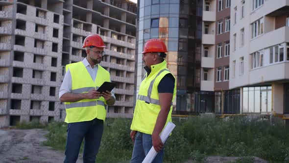 Happy Two Builders Talk About Their Work Together