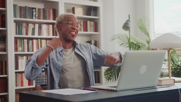 Excited African Man Celebrating Success Reading Good News in Email