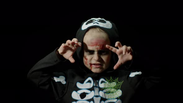 Halloween, Angry Girl with Blood Makeup on Face. Kid Dressed As Scary Skeleton, Posing, Making Faces