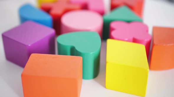Multicolored Wooden Blocks on a White Table Background Closeup
