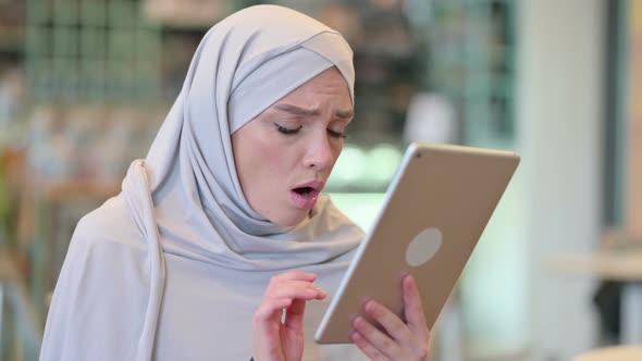 Portrait of Upset Young Arab Woman Having Loss on Tablet 