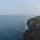 Aerial orbit shot around a Temple located near high rough cliffs and surrounded with ocean in Bali - VideoHive Item for Sale